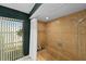 Tiled shower and tub with backyard view, perfect for a relaxing bathing experience at 838 Park Ct, Palm Harbor, FL 34683