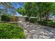 Well-maintained single-story home with an expansive driveway framed by verdant landscaping at 838 Park Ct, Palm Harbor, FL 34683