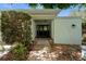 Welcoming front entrance with beautiful double doors, white siding and mature landscaping at 838 Park Ct, Palm Harbor, FL 34683