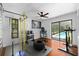 Well-equipped home gym with weightlifting equipment, tire and view of the outdoor pool at 838 Park Ct, Palm Harbor, FL 34683