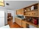 Kitchen with built-in shelving, wood cabinets and direct view of the dining area at 838 Park Ct, Palm Harbor, FL 34683