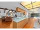 Bright eat-in kitchen with skylights and an adjacent living area at 838 Park Ct, Palm Harbor, FL 34683