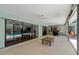 Spacious screened lanai features a bar, multiple seating areas, and view of the pool through sliding glass doors at 838 Park Ct, Palm Harbor, FL 34683
