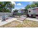 Backyard oasis showcasing a screened in pool area, hardscaped lounge area, and verdant landscaping at 9414 Northcliffe Blvd, Spring Hill, FL 34606