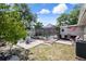 Expansive backyard with covered pool and patio area. Shaded spot to unwind, perfect for entertaining or enjoying quiet moments at 9414 Northcliffe Blvd, Spring Hill, FL 34606