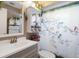 Bathroom featuring a sink, toilet and floral shower curtain at 9414 Northcliffe Blvd, Spring Hill, FL 34606