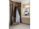 Bathroom features a vanity with a mirror reflecting the bedroom and a shower with a brown patterned curtain at 9414 Northcliffe Blvd, Spring Hill, FL 34606