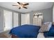 Comfortable bedroom featuring a ceiling fan, soft carpet and walk-in closet at 9414 Northcliffe Blvd, Spring Hill, FL 34606