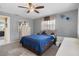 Comfortable bedroom featuring a ceiling fan, soft carpet and -and- nightstands at 9414 Northcliffe Blvd, Spring Hill, FL 34606