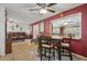 Cozy dining area featuring a wood table with chairs, red accent wall, and open access to living spaces at 9414 Northcliffe Blvd, Spring Hill, FL 34606