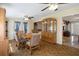 Open-concept dining room with parquet floors and decorative cabinet for ample storage at 9414 Northcliffe Blvd, Spring Hill, FL 34606
