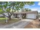 Charming single-story home featuring a well-maintained lawn, mature trees, and an attached garage with a boat parked nearby at 9414 Northcliffe Blvd, Spring Hill, FL 34606