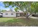 Inviting single-Gathering home with a well-manicured front lawn, mature shade trees, and a cozy, welcoming entrance at 9414 Northcliffe Blvd, Spring Hill, FL 34606