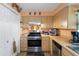Well-lit kitchen featuring stainless steel oven, ample counter space, and wooden cabinetry at 9414 Northcliffe Blvd, Spring Hill, FL 34606