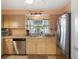 Modern kitchen with stainless steel appliances, double sink under a window, and light cabinets at 9414 Northcliffe Blvd, Spring Hill, FL 34606