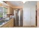 Spacious kitchen with stainless steel refrigerator, dual sink, and ample storage at 9414 Northcliffe Blvd, Spring Hill, FL 34606