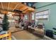 Eclectic living room with vintage furniture, quirky decorations, and natural light from a window at 9414 Northcliffe Blvd, Spring Hill, FL 34606
