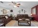 Comfortable living room with tile floors, neutral tones, and cozy leather furniture perfect for relaxing and entertaining at 9414 Northcliffe Blvd, Spring Hill, FL 34606