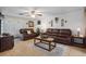 Comfortable living room with ceiling fan, neutral walls, tile floors, and leather furniture creating a welcoming atmosphere at 9414 Northcliffe Blvd, Spring Hill, FL 34606