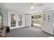 Bright living room featuring double doors leading to the pool area and backyard at 9414 Northcliffe Blvd, Spring Hill, FL 34606