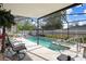 Enclosed pool area with sparkling water and ample seating, perfect for outdoor relaxation and entertaining at 9414 Northcliffe Blvd, Spring Hill, FL 34606