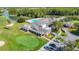 Stunning aerial view of clubhouse with pool, golf course, and serene water feature, creating a luxurious community setting at 9608 Rolling Cir, San Antonio, FL 33576