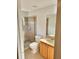 Clean bathroom featuring a glass shower, a light wooden vanity, and a mirror at 9608 Rolling Cir, San Antonio, FL 33576