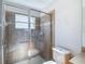 Shower with glass doors and tile surround, featuring a built-in seat at 9608 Rolling Cir, San Antonio, FL 33576