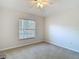 Empty bedroom with a window and neutral carpet at 9608 Rolling Cir, San Antonio, FL 33576