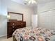 Bedroom featuring a ceiling fan and a wooden dresser and closet at 9608 Rolling Cir, San Antonio, FL 33576