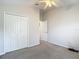 Empty bedroom featuring a closet, ceiling fan, and ensuite bathroom access at 9608 Rolling Cir, San Antonio, FL 33576