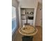 Bright dining area featuring tile flooring, a decorative round table, and convenient access to the laundry closet at 9608 Rolling Cir, San Antonio, FL 33576