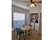 Bright dining area featuring tile flooring, a decorative round table, and convenient access to the laundry closet at 9608 Rolling Cir, San Antonio, FL 33576