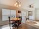 Dining room features stylish chandelier, wood floors, and adjacent laundry room at 9608 Rolling Cir, San Antonio, FL 33576