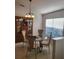 Formal dining room with elegant glass top table, seating for four, and a decorative hutch at 9608 Rolling Cir, San Antonio, FL 33576