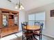 Cozy dining room with a wooden table, matching chairs, and a large window for natural light at 9608 Rolling Cir, San Antonio, FL 33576