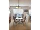 Dining room with a glass top table, 4 chairs, and a view to another room at 9608 Rolling Cir, San Antonio, FL 33576