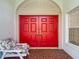 Inviting front porch with a colorful front door, creating a warm and welcoming entrance at 9608 Rolling Cir, San Antonio, FL 33576