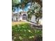 Charming single-story home with a screened front porch, lush lawn, and mature trees enhancing its curb appeal at 9608 Rolling Cir, San Antonio, FL 33576