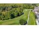 Scenic aerial view of a lush golf course featuring manicured greens, mature trees, and tranquil water features at 9608 Rolling Cir, San Antonio, FL 33576