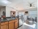 Open kitchen with stainless steel appliances, granite countertops, and view to the dining area at 9608 Rolling Cir, San Antonio, FL 33576