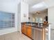 Modern kitchen with stainless steel dishwasher, wooden cabinets, and granite countertops at 9608 Rolling Cir, San Antonio, FL 33576