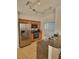 Well-equipped kitchen with stainless steel appliances, wooden cabinets, granite countertops, and a track lighting system at 9608 Rolling Cir, San Antonio, FL 33576
