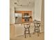 The kitchen has stainless steel appliances, wood cabinets and bar stool seating at 9608 Rolling Cir, San Antonio, FL 33576
