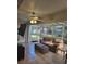 Relaxing sunroom featuring tiled floors, ample sunlight, comfortable seating, and a ceiling fan for added comfort at 9608 Rolling Cir, San Antonio, FL 33576