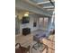Bright sunroom featuring tiled floors, comfortable seating, a ceiling fan, and plenty of natural light at 9608 Rolling Cir, San Antonio, FL 33576