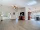 Spacious living room with hardwood floors and view to an adjacent dining room and sunroom at 9608 Rolling Cir, San Antonio, FL 33576