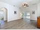 Bright living room featuring a ceiling fan, wood floors, and sliding doors to the backyard at 9608 Rolling Cir, San Antonio, FL 33576