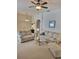 Open living room features two sofas, glass tables, neutral carpet and a ceiling fan at 9608 Rolling Cir, San Antonio, FL 33576