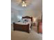 Comfortable main bedroom featuring a large bed, side tables with lamps, and neutral carpeting at 9608 Rolling Cir, San Antonio, FL 33576